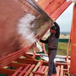 A worker is insulating an attic.