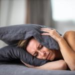 A woman is experiencing severe ear pain