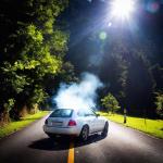 Smoke pours from a car's hood