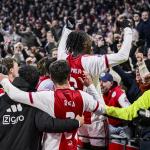 Ko Itakura, Lucas Rosa, and Jorthy Mokio of Ajax celebrate the 2–0 during the Dutch Eredivisie match between AFC Ajax and Feyenoord at the Johan Cruijff ArenA on December 14, 2025, in Amsterdam, Netherlands.