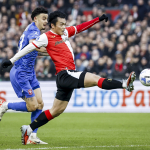 Stav Lemkin of FC Twente and Ayase Ueda of Feyenoord during the Dutch Eredivisie match between Feyenoord and FC Twente at Feyenoord Stadion De Kuip on December 21, 2025, in Rotterdam, the Netherlands.