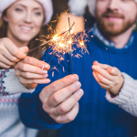 Family poses with sparklers on New Year’s Day.