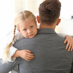  Father holds his daughter, who is ill with chickenpox