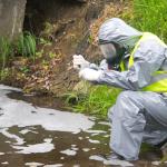 Scientist checks water body for possible contamination