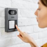 Woman rings a doorbell 