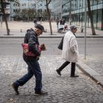 Older people walking on a street.