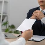 Worker hands in a resignation letter