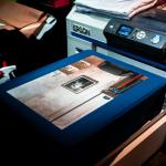 A close-up image of a high quality printed photograph in front of a commercial Epson SureColor printer