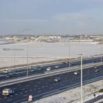 Cars drive past Schiphol Airport in the afternoon, while dozens of aircraft remained on the ground after a snowstorm passed the area. 5 Jan. 2026