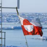The flag of Greenland on a tourist boat mast.