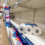 Empty toilet paper shelves in a supermarket