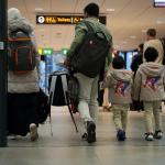 A Syrian family walks through Schiphol Airport before departing the Netherlands.
