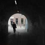 A woman rides through a tunnel