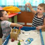 Children playing at a sand table