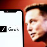 The Grok AI tool logo with Elon Musk in the background 