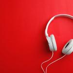 White headphones on a red brackground