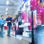 A man is choosing a TV to buy.