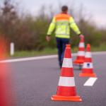 Archive photo of a Rijkswaterstaat worker placing cones to close a lane on a road