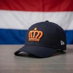 Artist’s rendering of the 2026 Kingdom of the Netherlands baseball hat in front of a Dutch fl