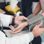 Cropped shot of doctor measuring a woman's blood pressure