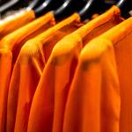 Orange tops at a clothing store.