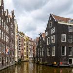 The rear facades of buildings on the Zeedijk at the intersection of to Amsterdam city center canals, Oudezijds Voorburgwal and Oudezijds Achterburgwal. July 2025
