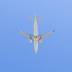 Under view of a commercial airplane flying on blue sky