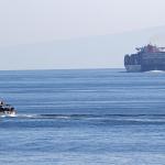 A U.S. Coast Guard cutter and a cargo ship in the Strait of Hormuz, 2 December 2020
