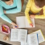 Mother and daughter doing schoolwork together.