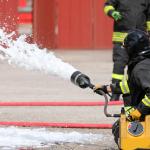 Firefighter uses firefighting foam.
