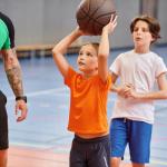 Kids play basketball at school.