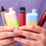 A person holding a variety of vapes