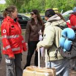 Red Cross volunteers speaking with people arriving at the asylum registration center in Ter Apel, May 2026