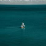 A white and brown sailing yacht out on the open water in 2019