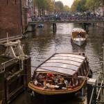 People on a canal boat tour in Amsterdam in 2022.
