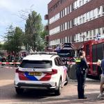 Police talk to residents as firefighters respond to an explosion and fire on Ombilinstraat in Amsterdam. 20 June 2026