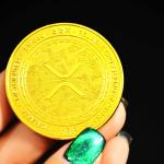 A physical coin meant to represent an XRP (Ripple) token. 2021