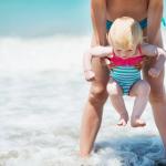 Playing with a baby on a beach.