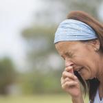 A woman sneezes.
