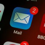The Apple Mail app icon on an iPhone screen alongside icons for Google News and BBC News. 2020
