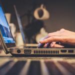 A silver laptop with several USB, audio, and video ports. 2018