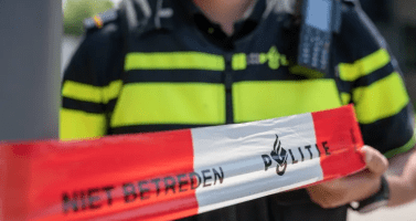 Police officer cordoning off a crime scene