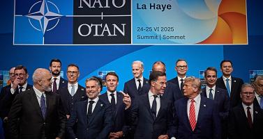 NATO Secretary General Mark Rutte pointing past a grinning Dutch Prime Minister Dick Schoof while speaking with U.S. President Donald Trump at the start of the NATO Summit in The Hague. 24 June 2025