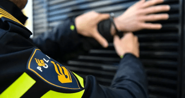 Police officer arrests a suspect.